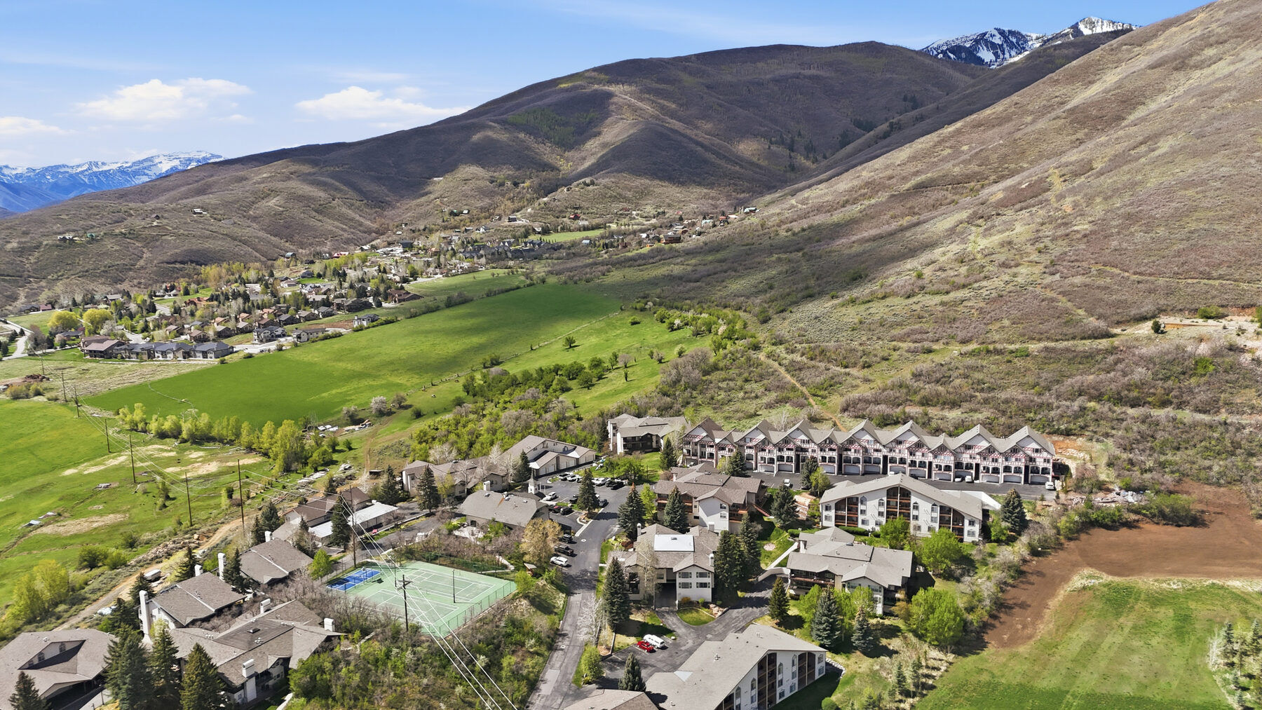 Aerial view of Swiss Oaks condominiums below the Wasatch Back mountains Midway