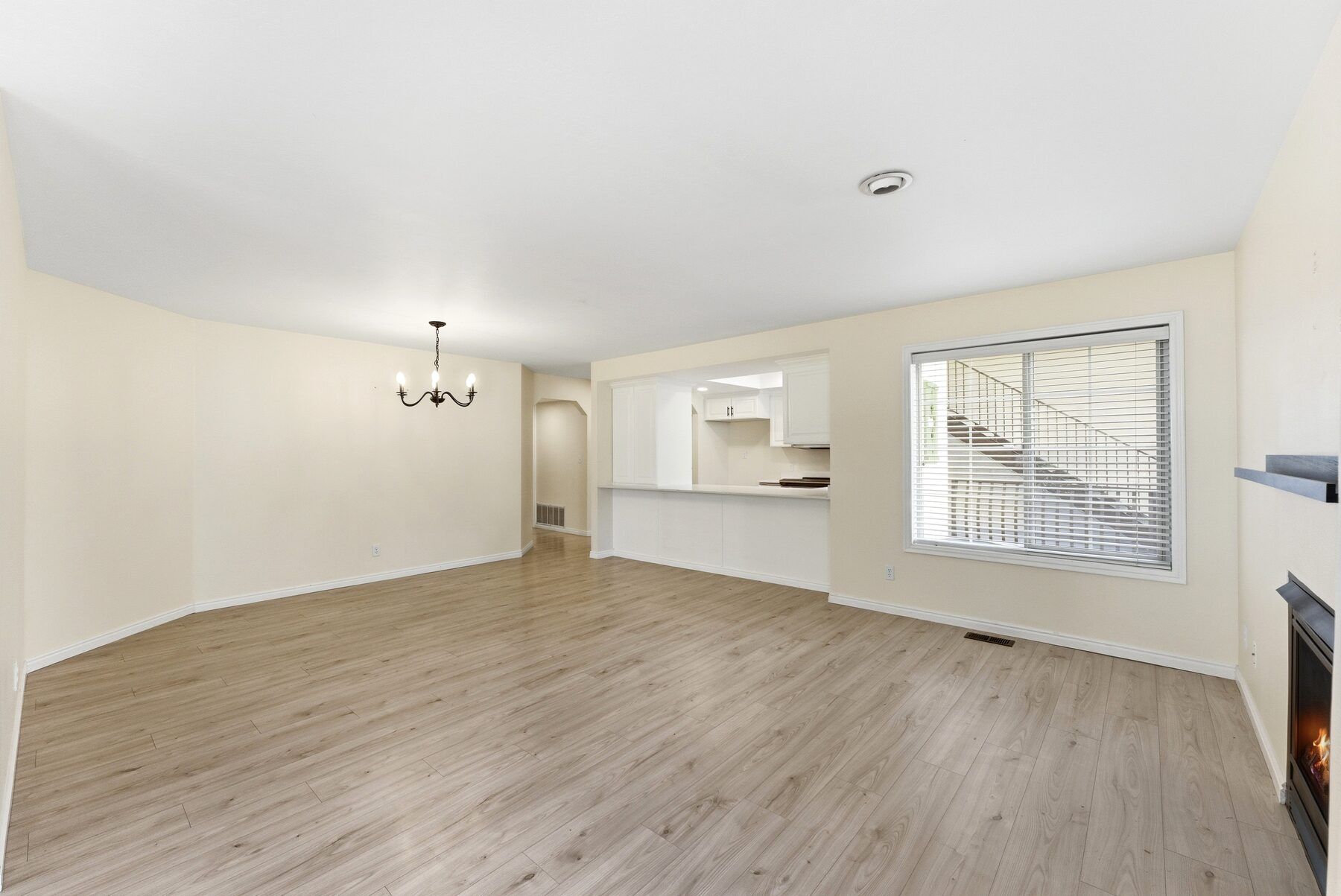 Open living and dining room with gas fireplace in remodeled Swiss Oaks condo Midway Utah