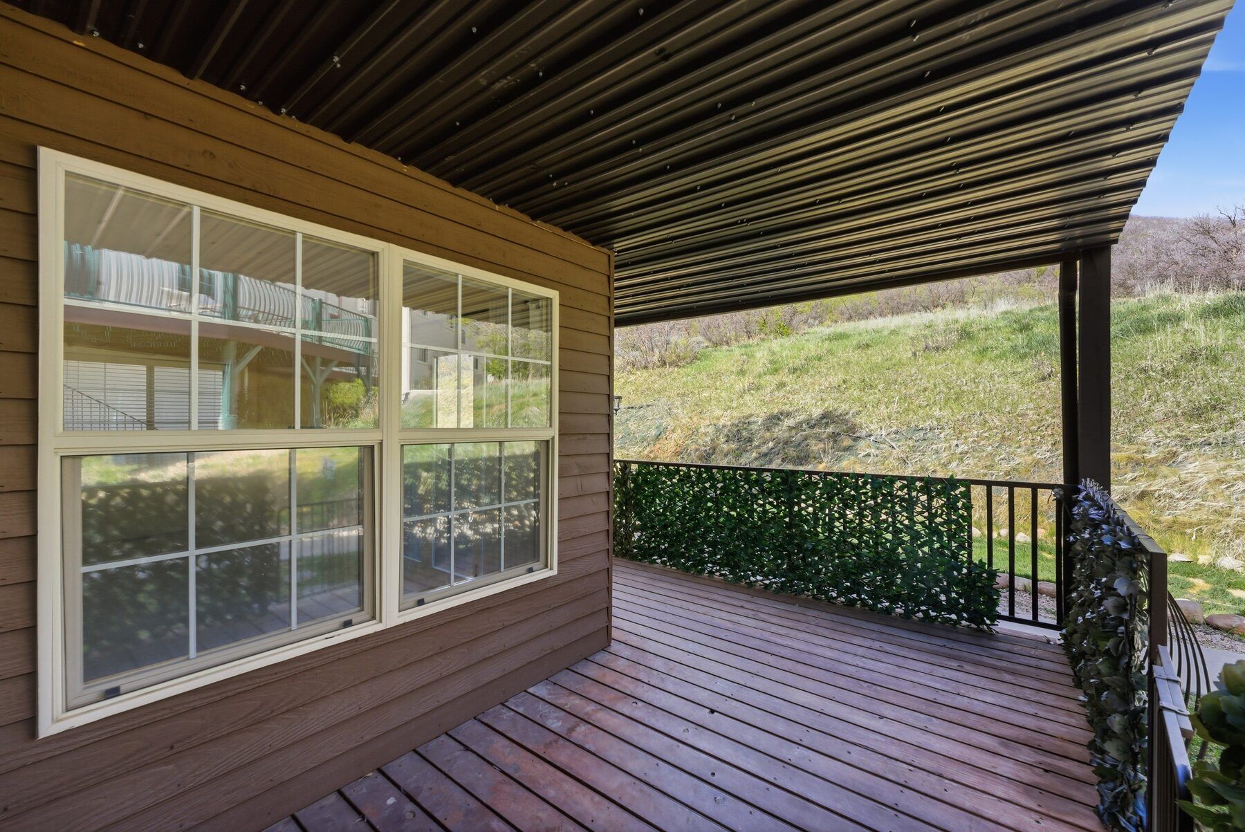 Covered patio with window wall and mountain view at 1041 W Grindelwald Midway condo