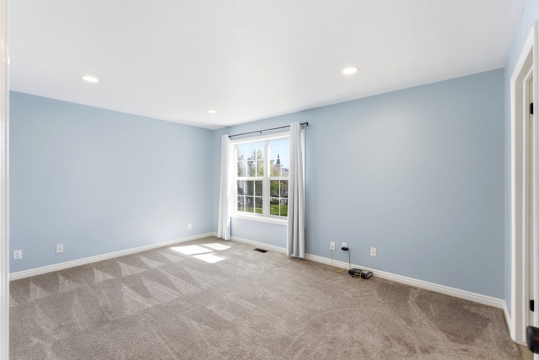 Primary bedroom with ensuite and walk-in closet access in Midway condo