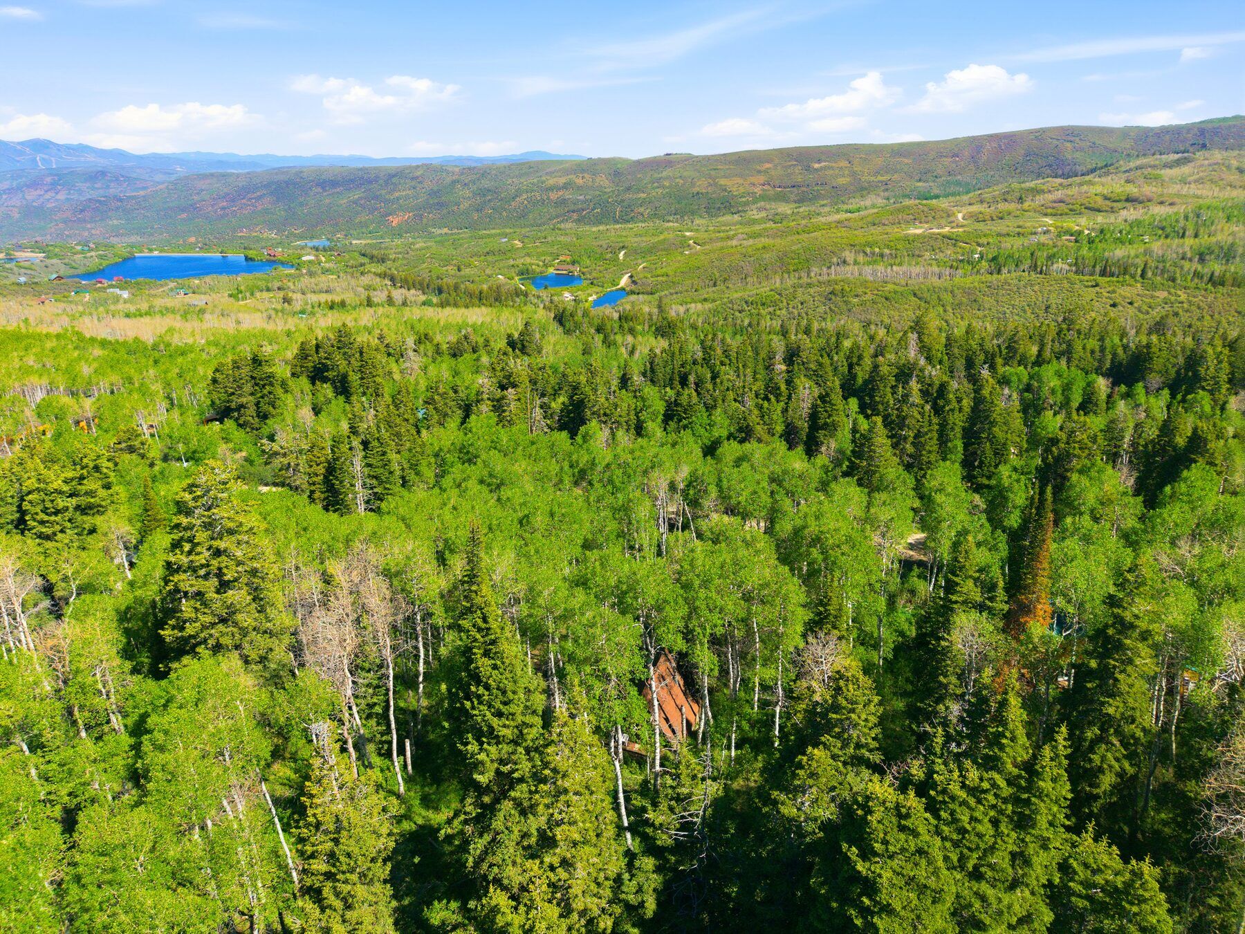 Aerial of the wooded Timber Lakes community above Heber Valley Utah
