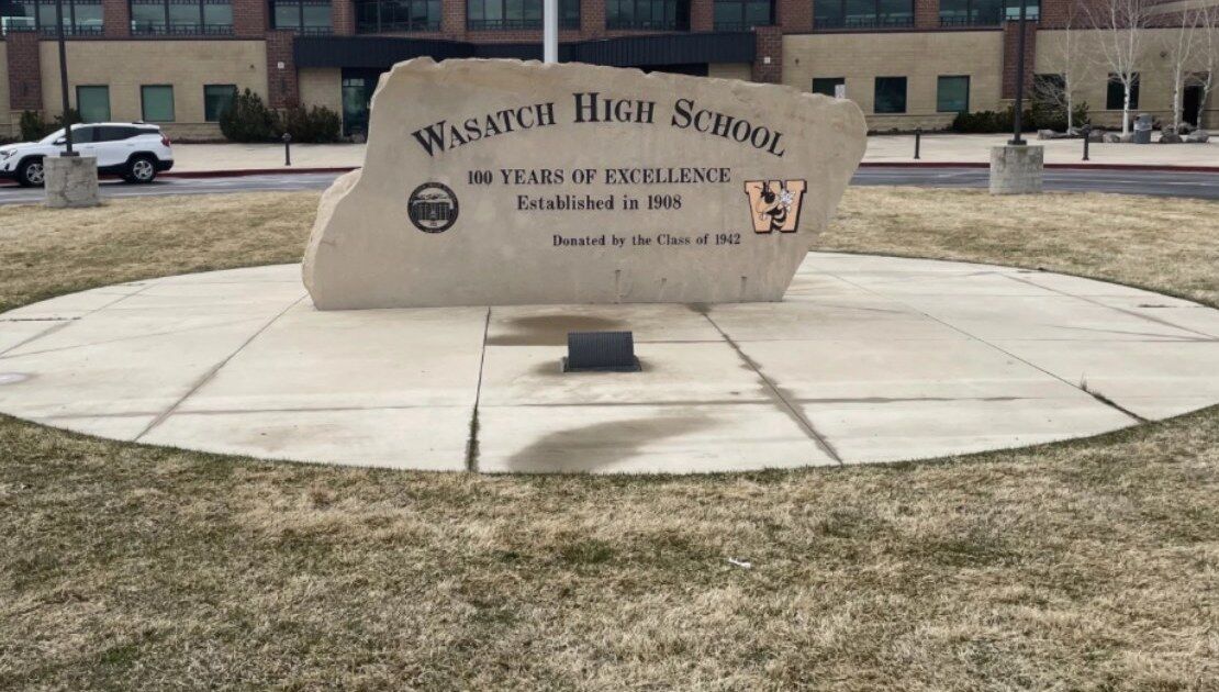 Wasatch High School entrance monument in Heber City, Utah, engraved with '100 Years of Excellence, Established in 1908'